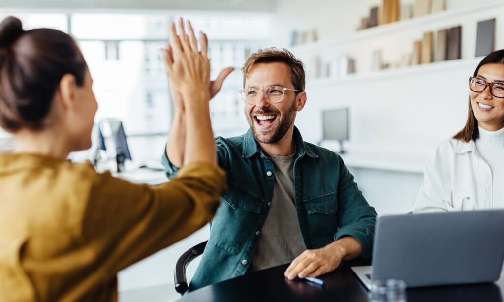 Motivierte Mitarbeiter geben sich High Five