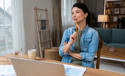 Business woman video call preparation. Young female businessperson prepare herself for online meeting, making notes for internet presentation, thinking and planning for better achievement with client