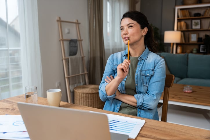 Business woman video call preparation. Young female businessperson prepare herself for online meeting, making notes for internet presentation, thinking and planning for better achievement with client