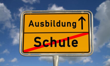 German road sign school and apprenticeship with blue sky and white clouds