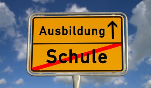 German road sign school and apprenticeship with blue sky and white clouds